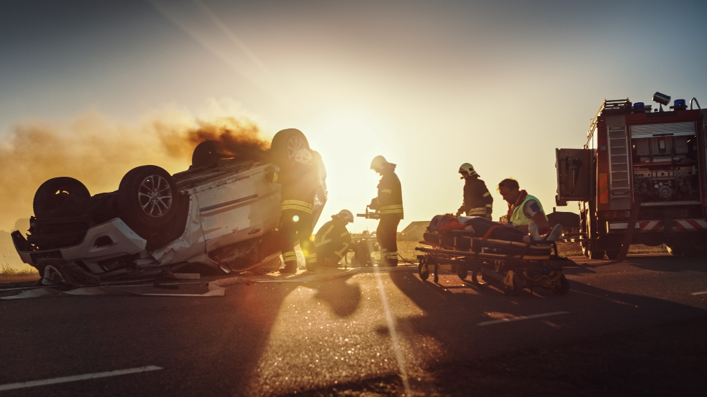Medics provide first aid to women on stretchers after a traffic accident